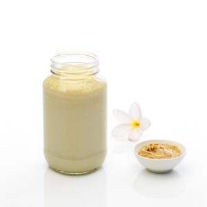 Vanilla peanut butter shake in a glass jar with peanut butter